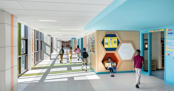 Children walking down a hallway in a school